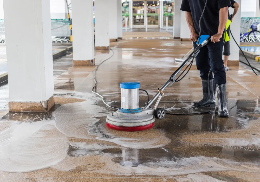 asian-worker-cleaning-sand-wash-exterior-walkway